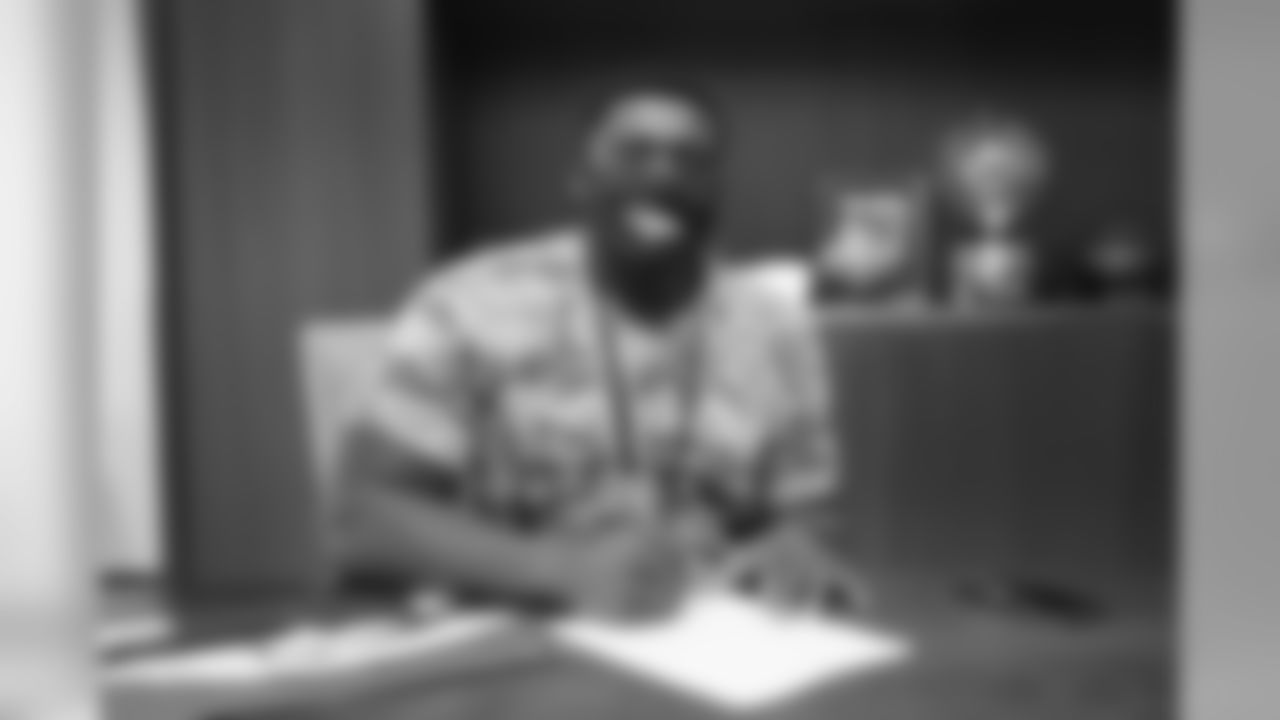 Lloyd Cushenberry III signs his rookie contract in Pat Bowlen's conference room at UCHealth Training Center on July 27, 2020. (Photo by Ben Swanson)