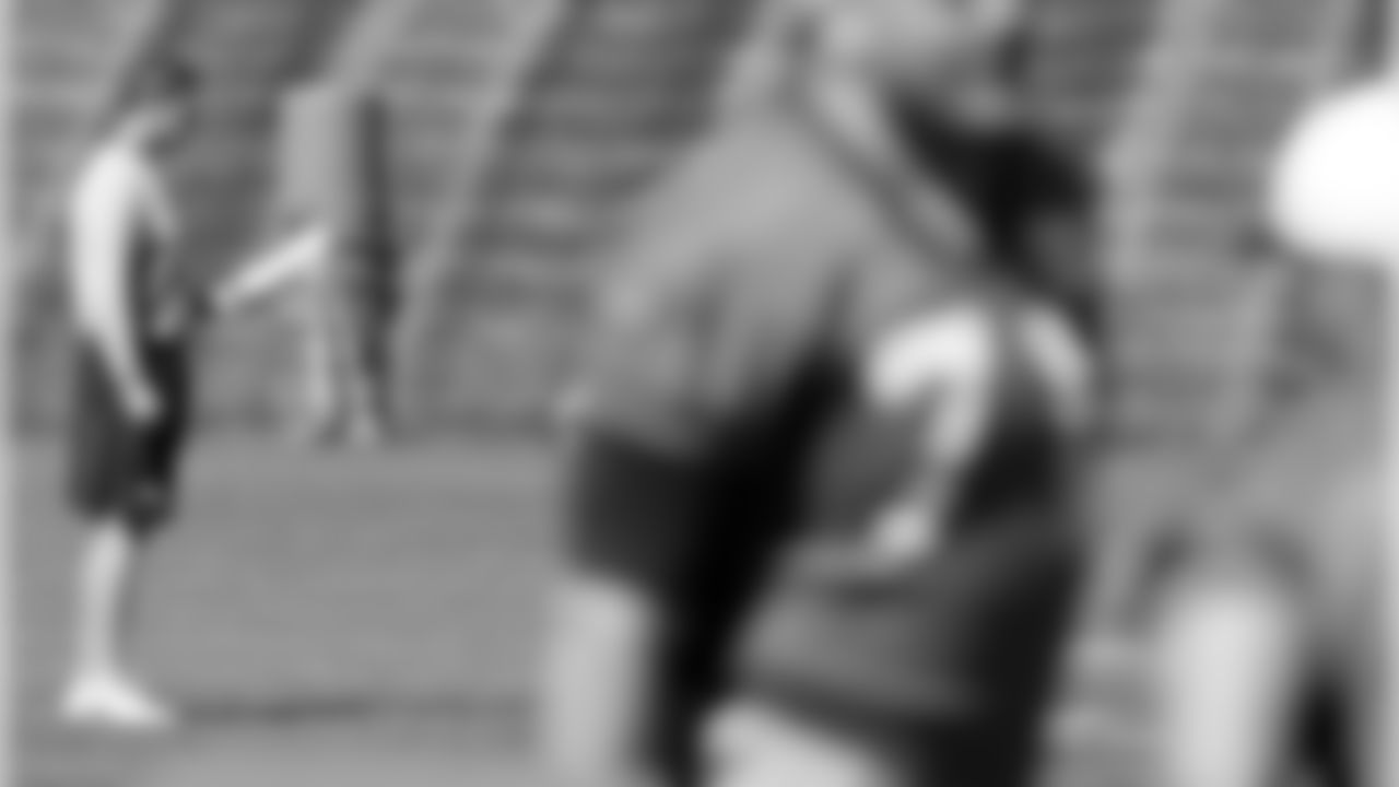 Offensive Coordinator Rick Dennison watches over practice on the second day of voluntary vet minicamp.