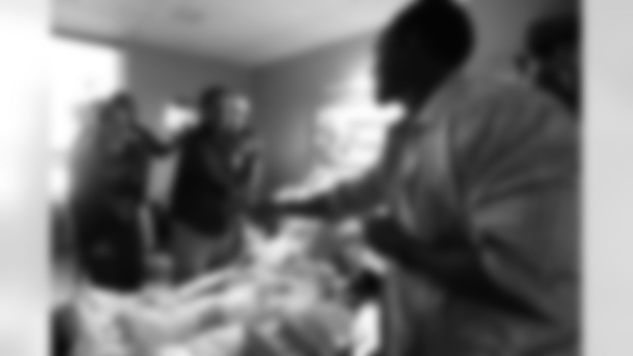 Brian Dawkins visits with Josh Nowlen and his family.