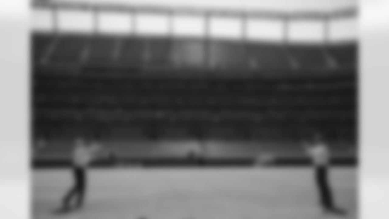 Peyton Manning throws a football with John Elway while they conduct an interview during the taping of an episode of Peyton's Places at Empower Field at Mile High on June 26, 2020. (Photo by Ben Swanson)