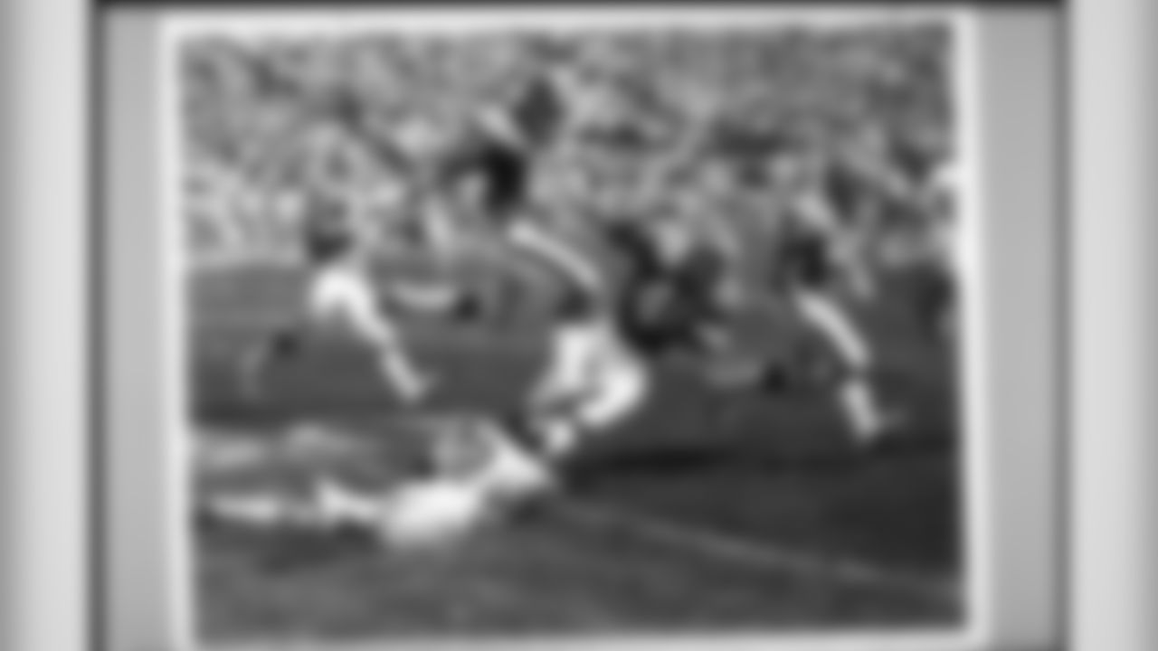 Paul Howard (1973 NFL Draft - third round, 54th overall) leaps over an opponent to try to make a block down the field. Howard played for 13 years in the NFL, all with the Broncos, starting in at least 147 of 187 career games.