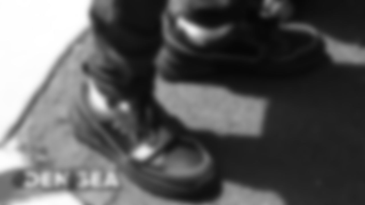 Will Parks shows off his shoes during the walk to the team buses for the Broncos' travel to Seattle on August 7, 2019 ahead of their game against the Seahawks.