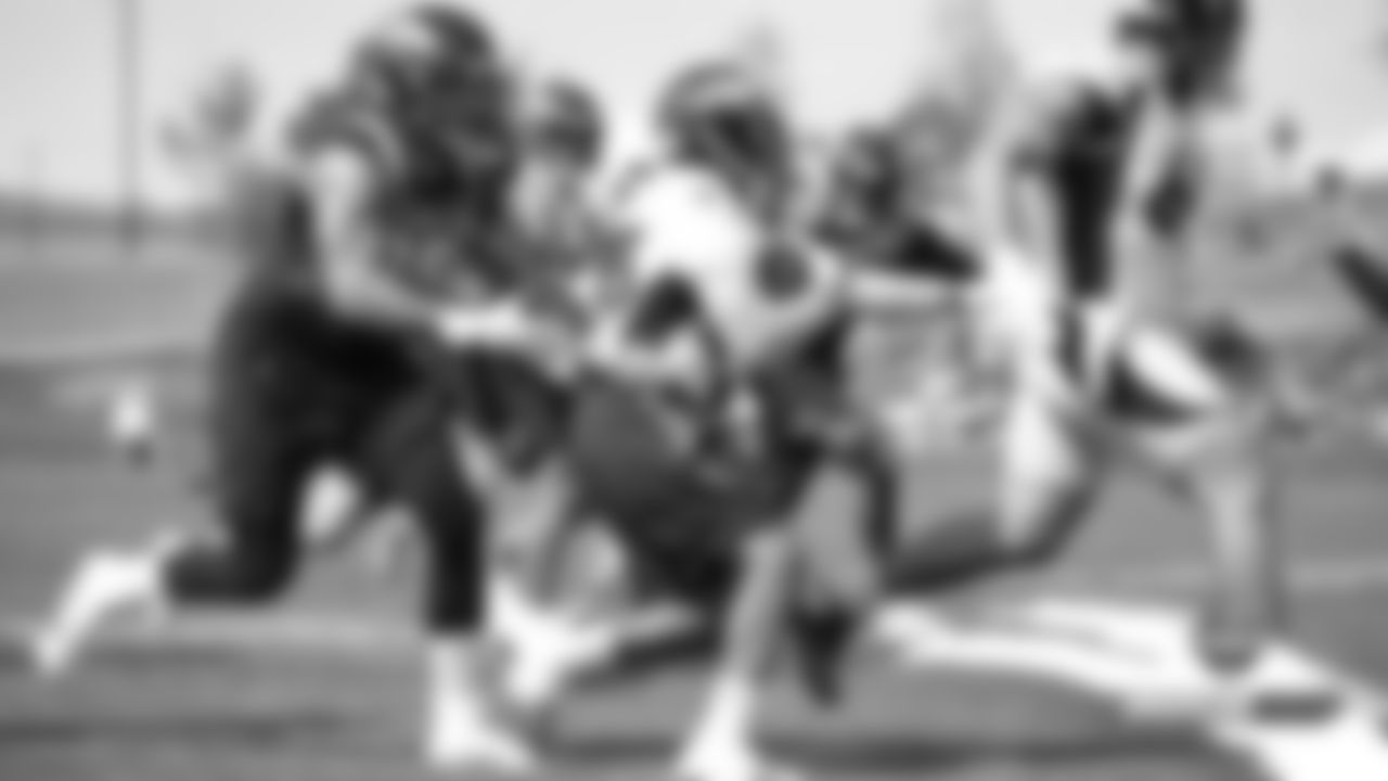 Derek Wolfe wraps up Devontae Booker during practice on Day 11 of training camp on July 30, 2019.