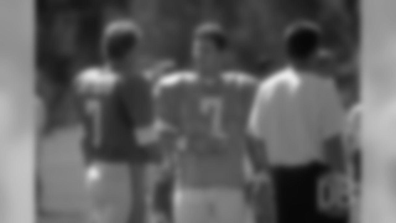 Quarterback John Elway talks with Panthers quarterback Steve Buerlein during a scrimmage at the 1996 training camp in Greeley.