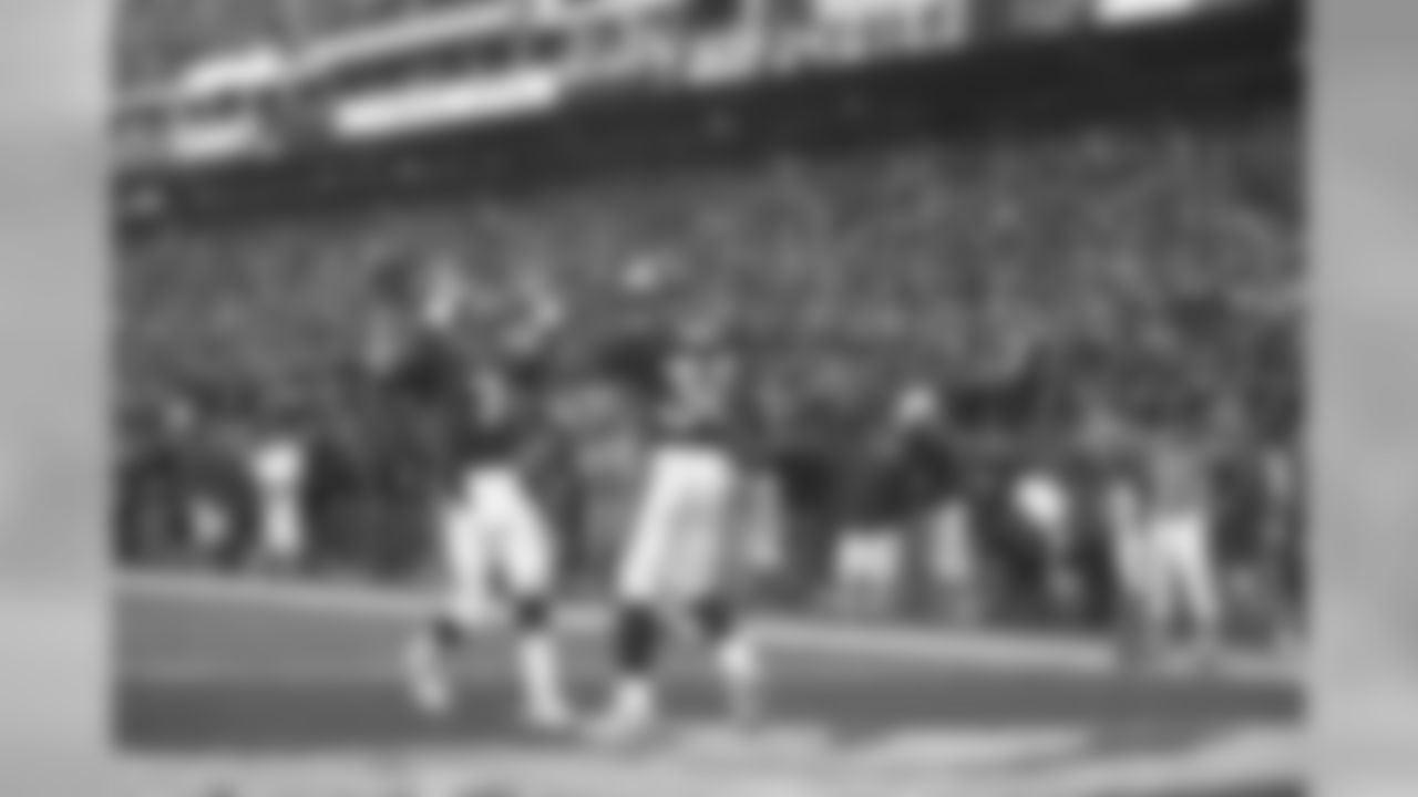 Terrell Davis is congratulated by John Elway after Davis rushed for a touchdown against the Miami Dolphins at Mile High Stadium in Denver, CO on January 9, 1999.