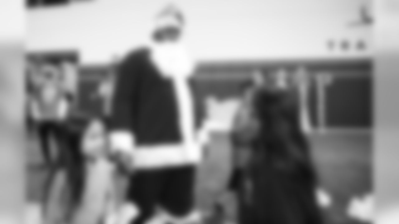 Shelby Harris, dressed as Santa Claus, talks with children at the 2019 Boys & Girls Club holiday party hosted by the Broncos for nearly 200 children from the Boys & Girls Clubs of Metro Denver on December 16, 2019 at UCHealth Training Center. (Photo by Jeremy Rincon)