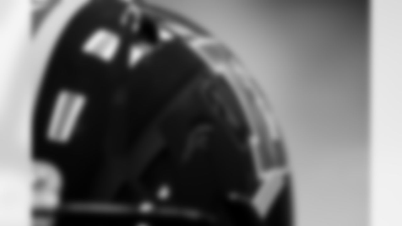 Members of the equipment staff place Color Rush decals on players' helmets at UCHealth Training Center in Englewood, Colorado on November 9, 2021. (Photo by Ben Swanson)