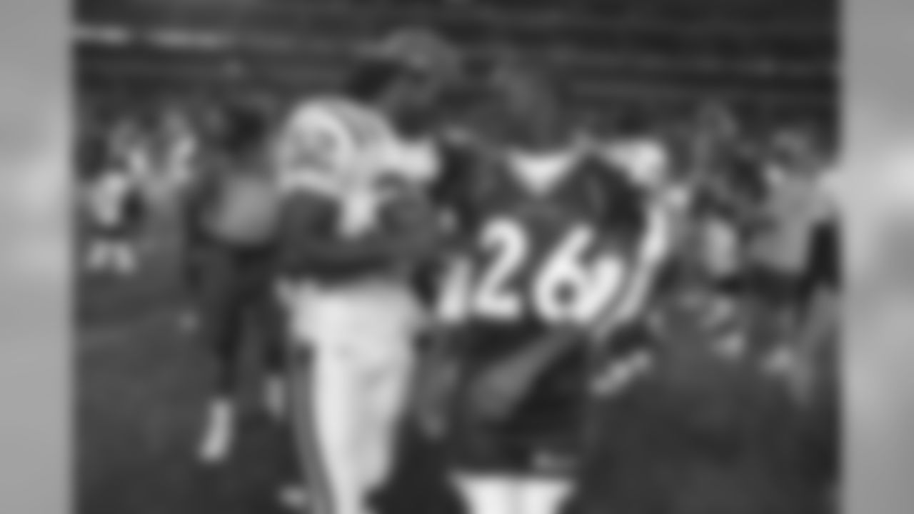 Edgerrin James and Clinton Portis joke around after the game against the Indianapolis Colts at INVESCO Field at Mile High in Denver, CO on August 25, 2003. The two both starred at the University of Miami before entering the NFL.