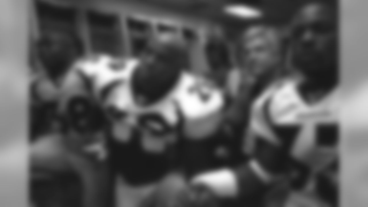 Howard Griffith holds hands with teammates during a postgame talk against the New Orleans Saints at Louisiana Superdome in New Orleans, LA on December 3, 2000.