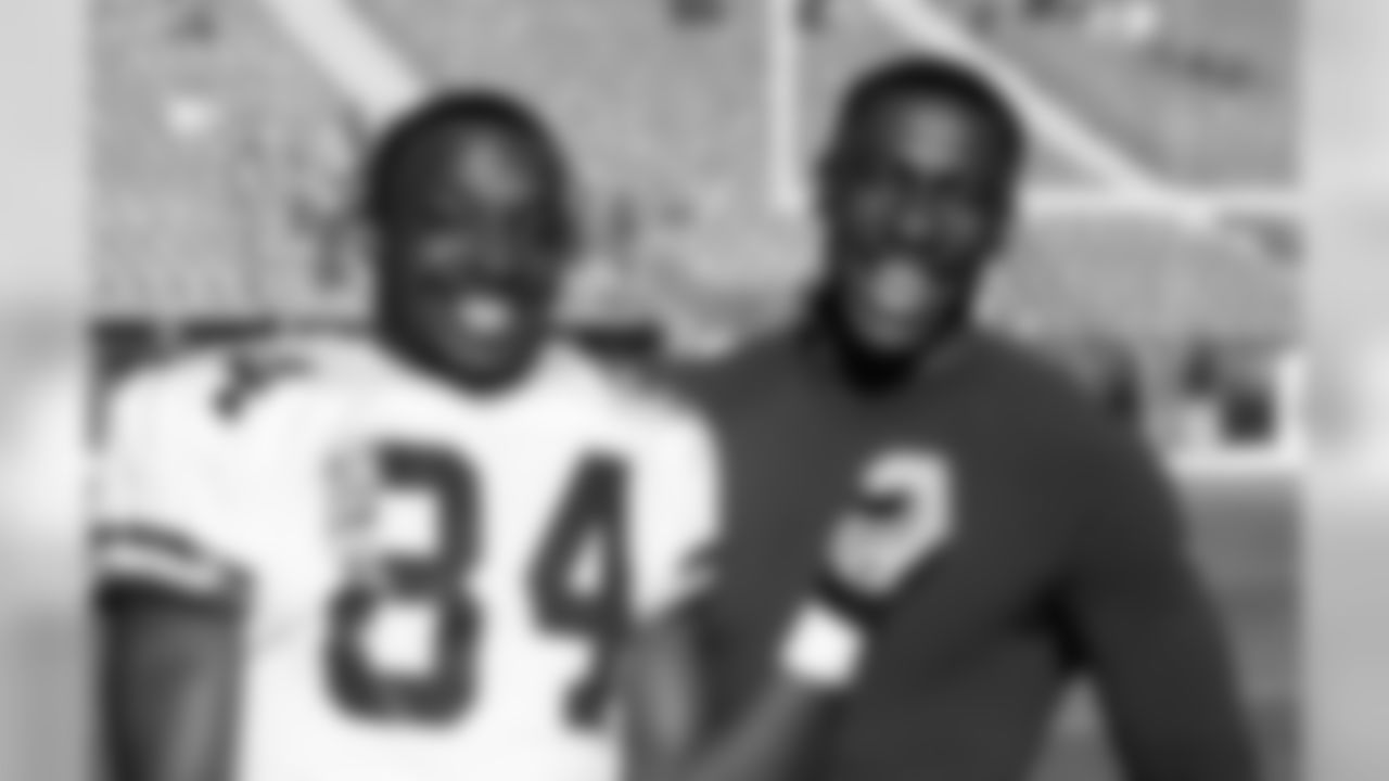 Green Bay Packers wide receiver Sterling Sharpe (84) poses with his brother Denver Broncos tight end Shannon Sharpe before the start of an NFL game Dec. 30, 1990, in Denver. The Broncos defeated the Packers 22-13. (Tony Tomsic via AP)