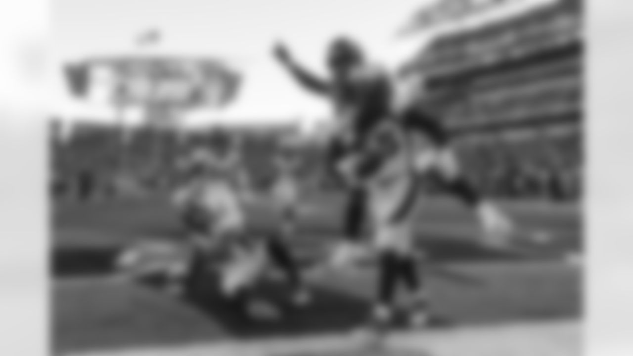 Von Miller jumps on Bradley Chubb's back as he celebrates Chubb's strip-sack forced fumble and fumble recovery during the Broncos' Week 13 game against the Cincinnati Bengals at Paul Brown Stadium.