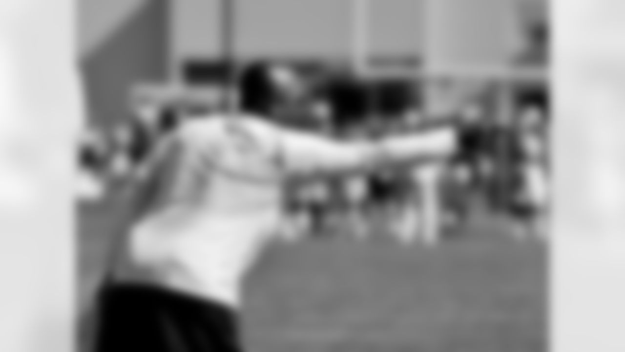Secondary Coach Ron Milus signals during practice.