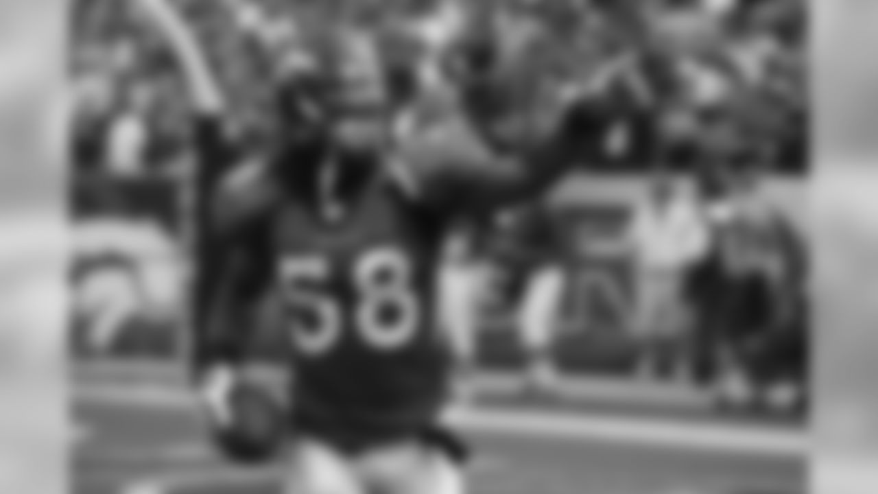Nate Webster gestures to the west stands after he scored a touchdown on a fumble recovery in the second quarter against the New Orleans Saints on September 21, 2008 at Invesco Field.