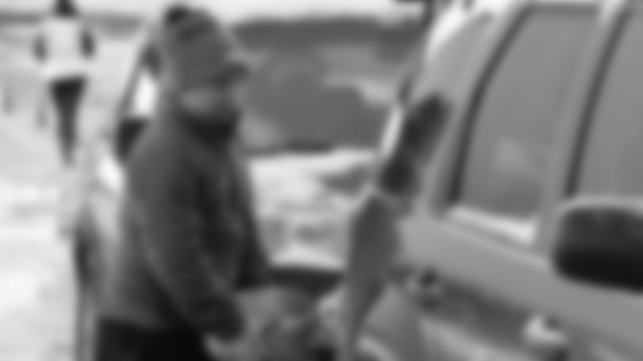 A volunteer loads a turkey into a car at Thanksgiving ÔBanquet in a BoxÕ Turkey Distribution outside Empower Field at Mile High on November 27, 2019 (Photo by Emily Simanskis)