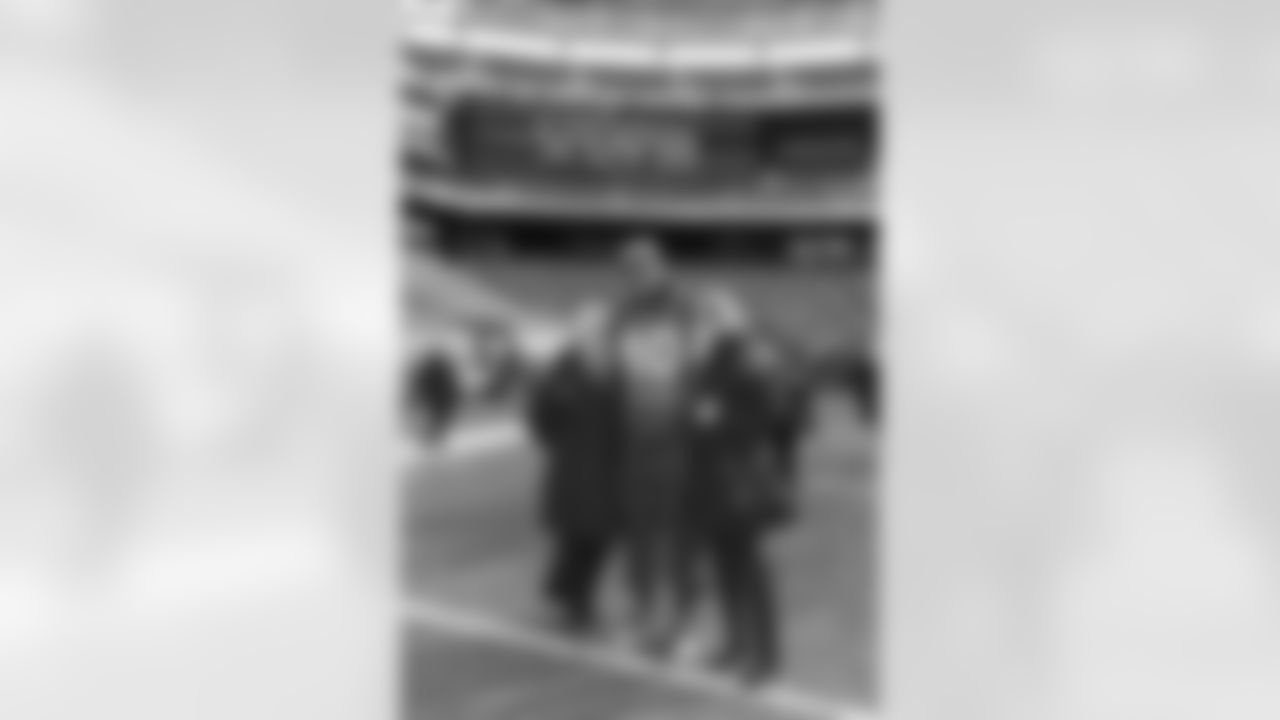 Kathy Hatch, Executive Assistant to President of Football Operations/GM, and a friend pose for a photo with tight end Julius Thomas after a team walk-through at Super Bowl XLVIII at MetLife Stadium in East Rutherford, NJ. ©Trevor Brown, Jr./Trevor Brown Photography
