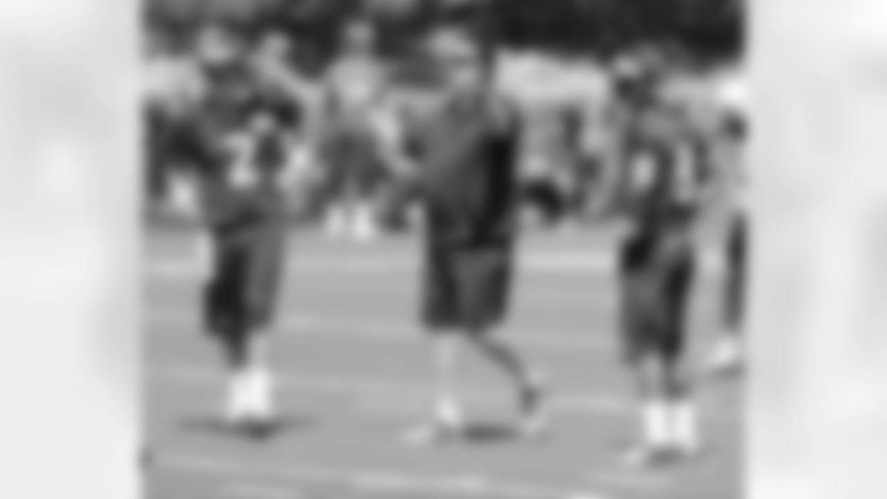 QB Coach Greg Knapp talks to his two passers.
