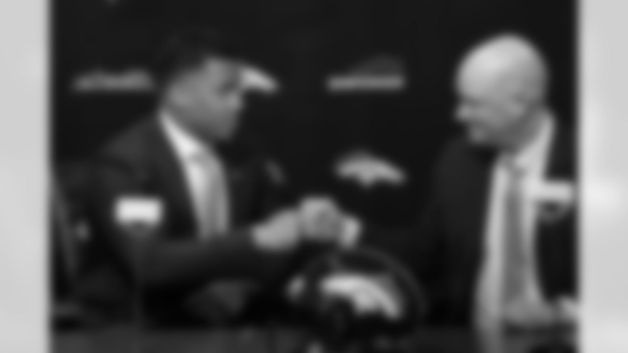 Russell Wilson does a fist bump with Head Coach Nathaniel Hackett at Wilson's introductory press conference at UCHealth Training Center on March 16, 2022. (Photo by Ben Swanson)