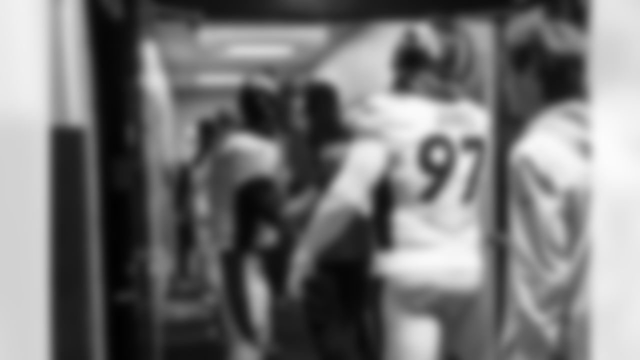 Russell Wilson encourages D.J. Jones and teammates as they re-enter the locker room after pregame warmups before the Broncos' Week 12 game against the Carolina Panthers at Bank of America Stadium in Charlotte, North Carolina on November 27, 2022. (Photo by Ben Swanson)
