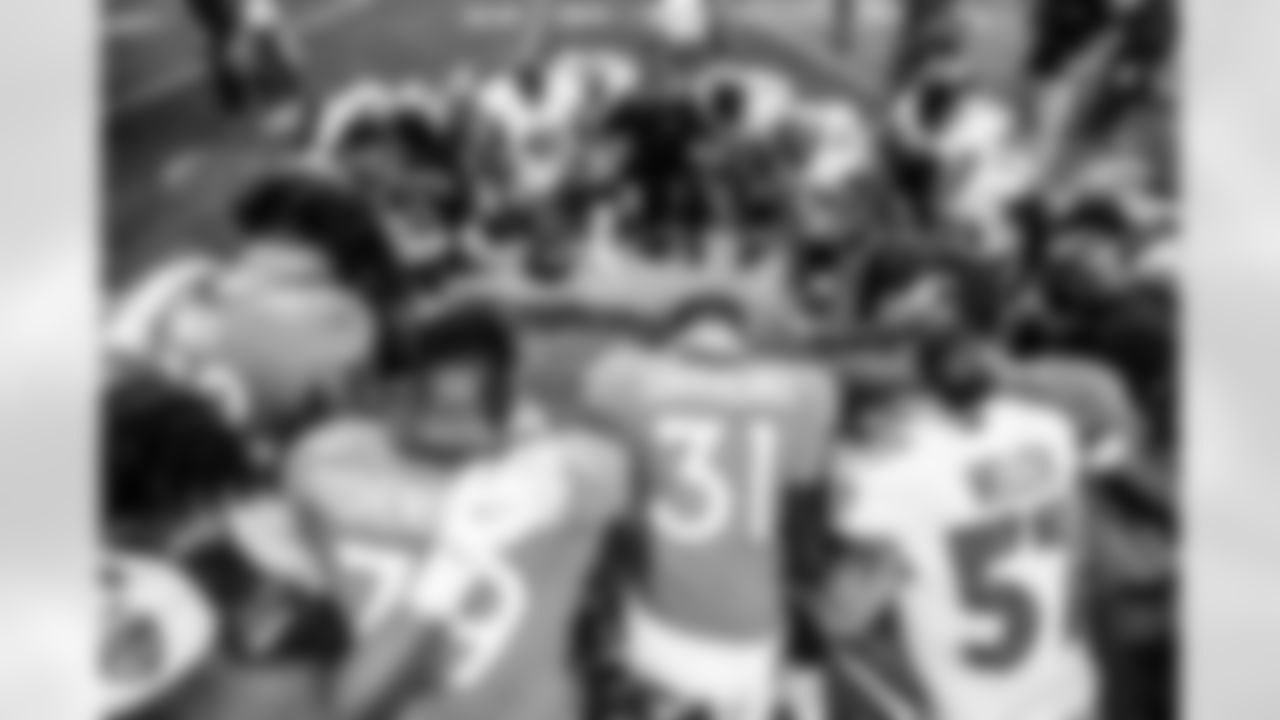 Netane Muti, Lloyd Cushenberry III, Justin Simmons and members of both teams pray together after the Broncos' Week 4 game against the Baltimore Ravens on October 3, 2021 at Empower Field at Mile High in Denver, Colorado. (Photo by Pete Eklund)