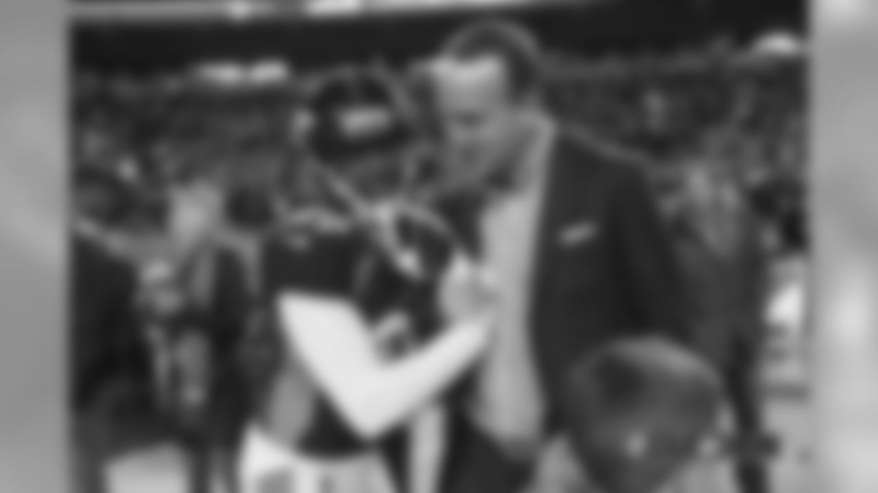 Peyton Manning talks with Bradley Roby before the Broncos' Week 15 game against the Cleveland Browns at Broncos Stadium at Mile High on December 15, 2018.