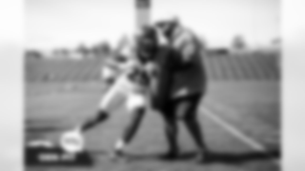 Melvin Gordon III and Running Backs Coach Curtis Modkins during practice at UCHealth Training Center in Englewood, Colorado on October 8, 2021. (Photo by Ben Swanson)
