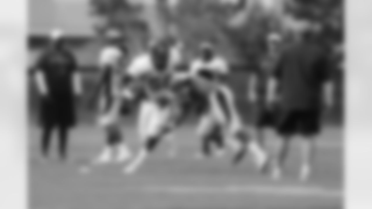 Linebacker work through a tackling drill.