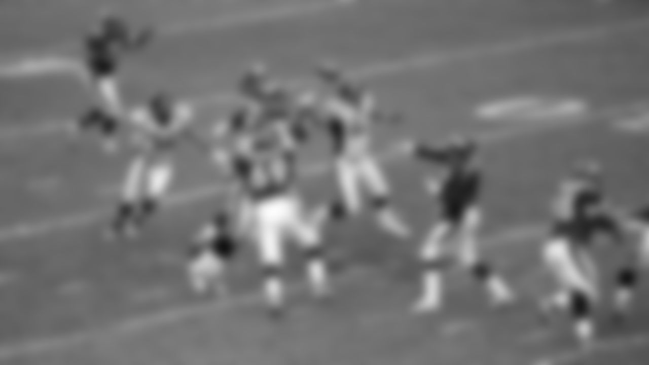 John Elway uncorks a pass during the Broncos' 42-17 win over the Jacksonville Jaguars in the Wild Card round of the 1997 playoffs on December 27, 1997 at Mile High Stadium.