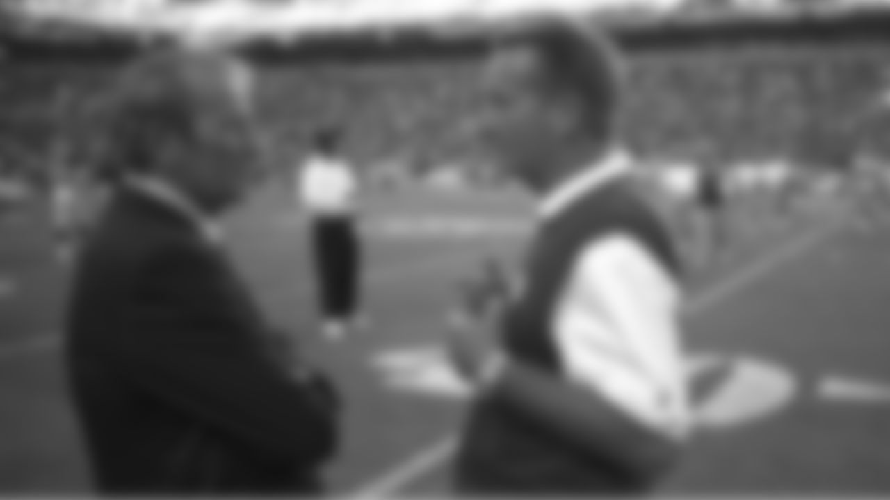 Pat Bowlen chats with Jim Fassel before the start of the game against the New York Giants at Invesco Field at Mile High in Denver, CO on September 10, 2001. Fassel previously was an offensive coordinator for the Broncos from 1993-94.