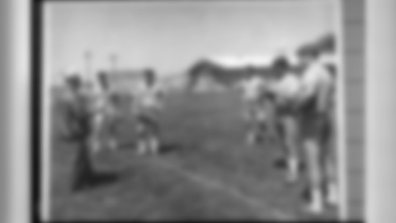 Head coach/general manager Lou Saban coaches players at a 1967 training camp.