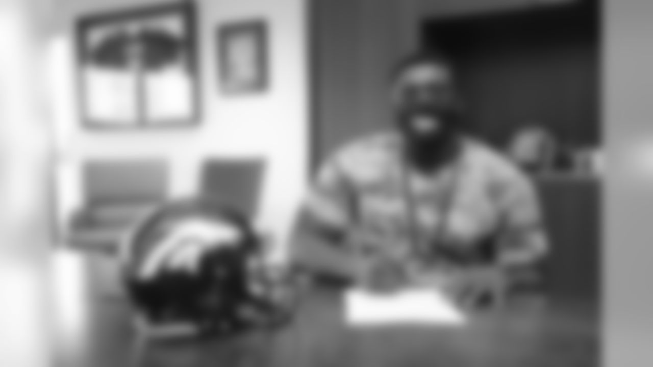 Lloyd Cushenberry III signs his rookie contract in Pat Bowlen's conference room at UCHealth Training Center on July 27, 2020. (Photo by Ben Swanson)