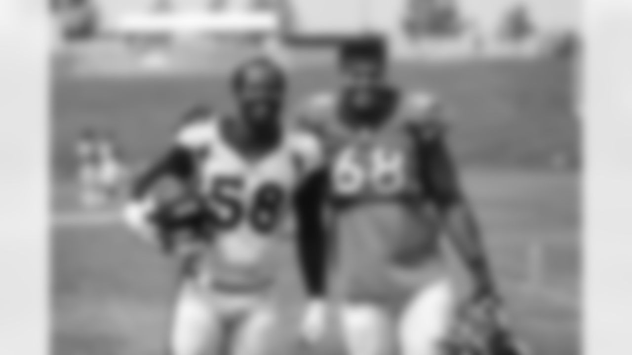 Von Miller and Elijah Wilkinson pose for a photo after practice on Day 11 of training camp at UCHealth Training Center on August 28, 2020. (Photo by Ben Swanson)