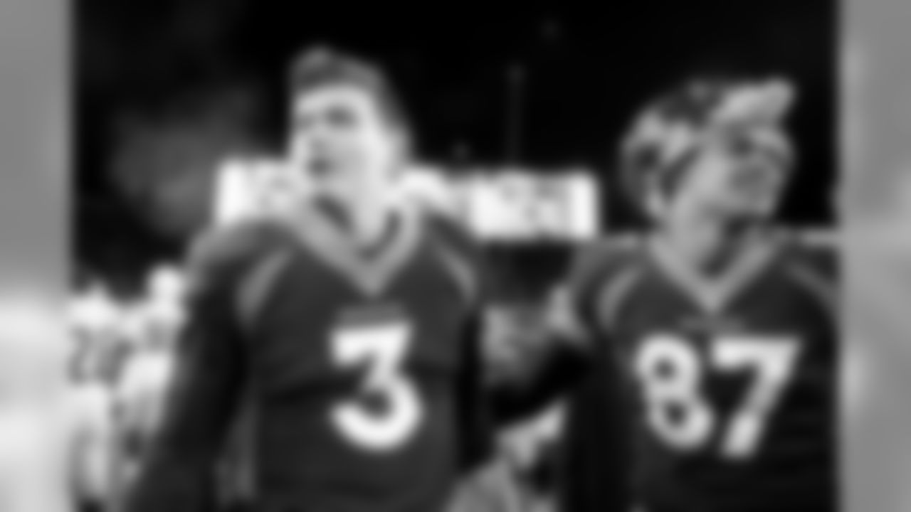 Drew Lock and Noah Fant celebrate after the Broncos' 23-20 win over the Los Angeles Chargers at Empower Field at Mile High on December 1, 2019. (Photo by Ben Swanson)