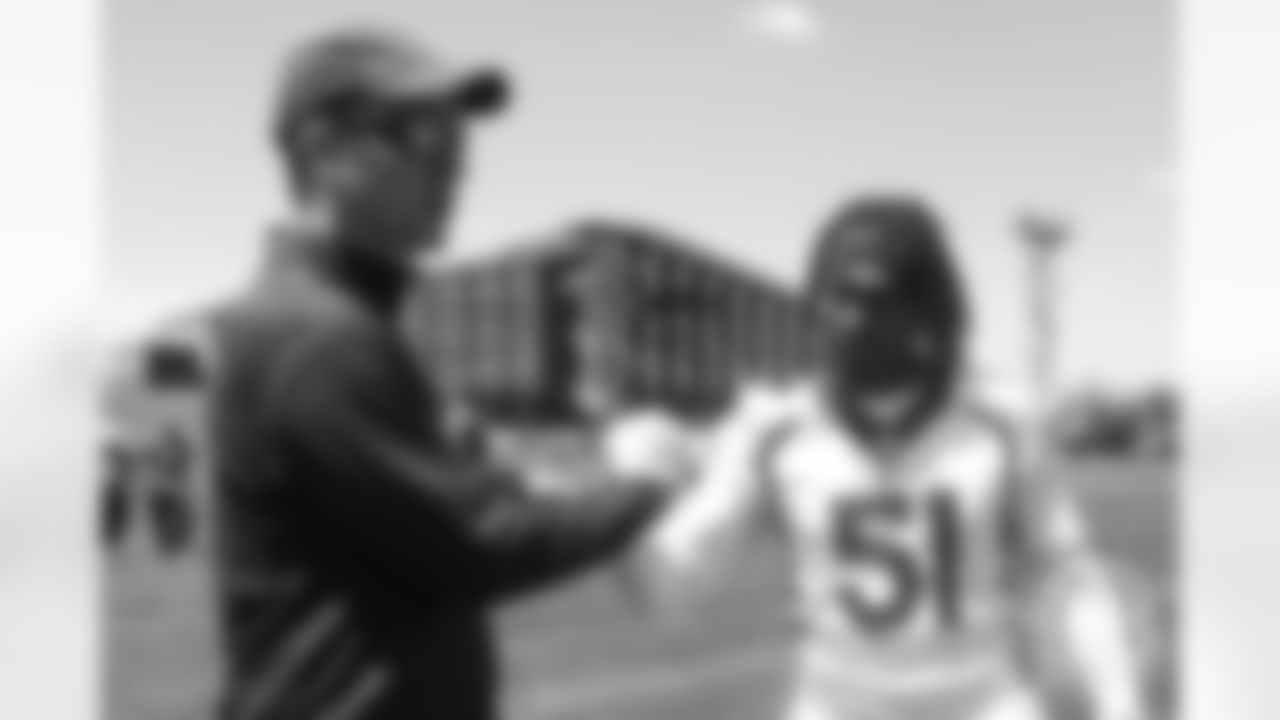 Todd Davis greets former Broncos quarterback Peyton Manning after the Broncos' practice on the eight day of their OTAs on May 30, 2019.