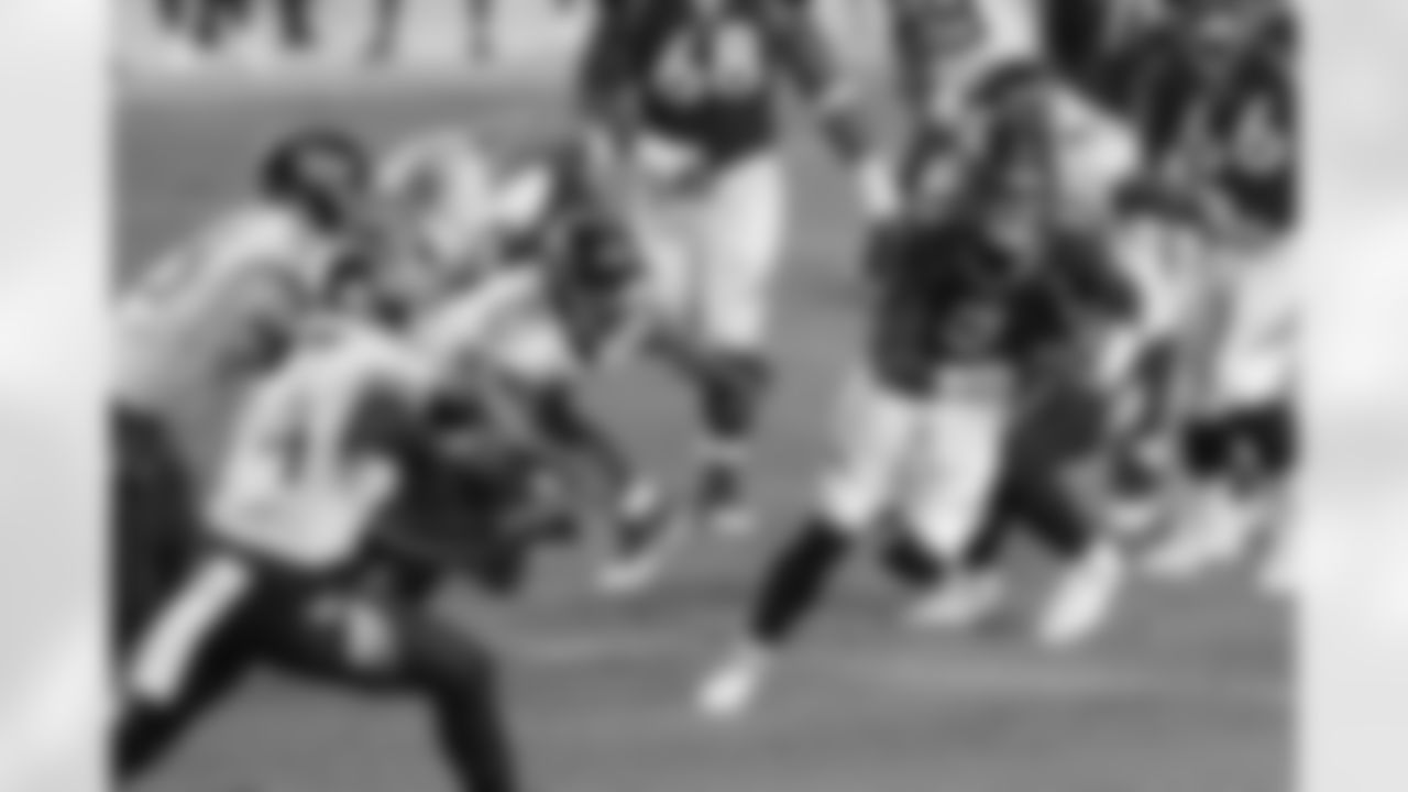 Drew Lock scrambles away from Titans defenders during the first half of the Broncos' Week 1 game against the Tennessee Titans at Empower Field at Mile High in Denver, Colorado, on September 14, 2020. (Photo by Ben Swanson)