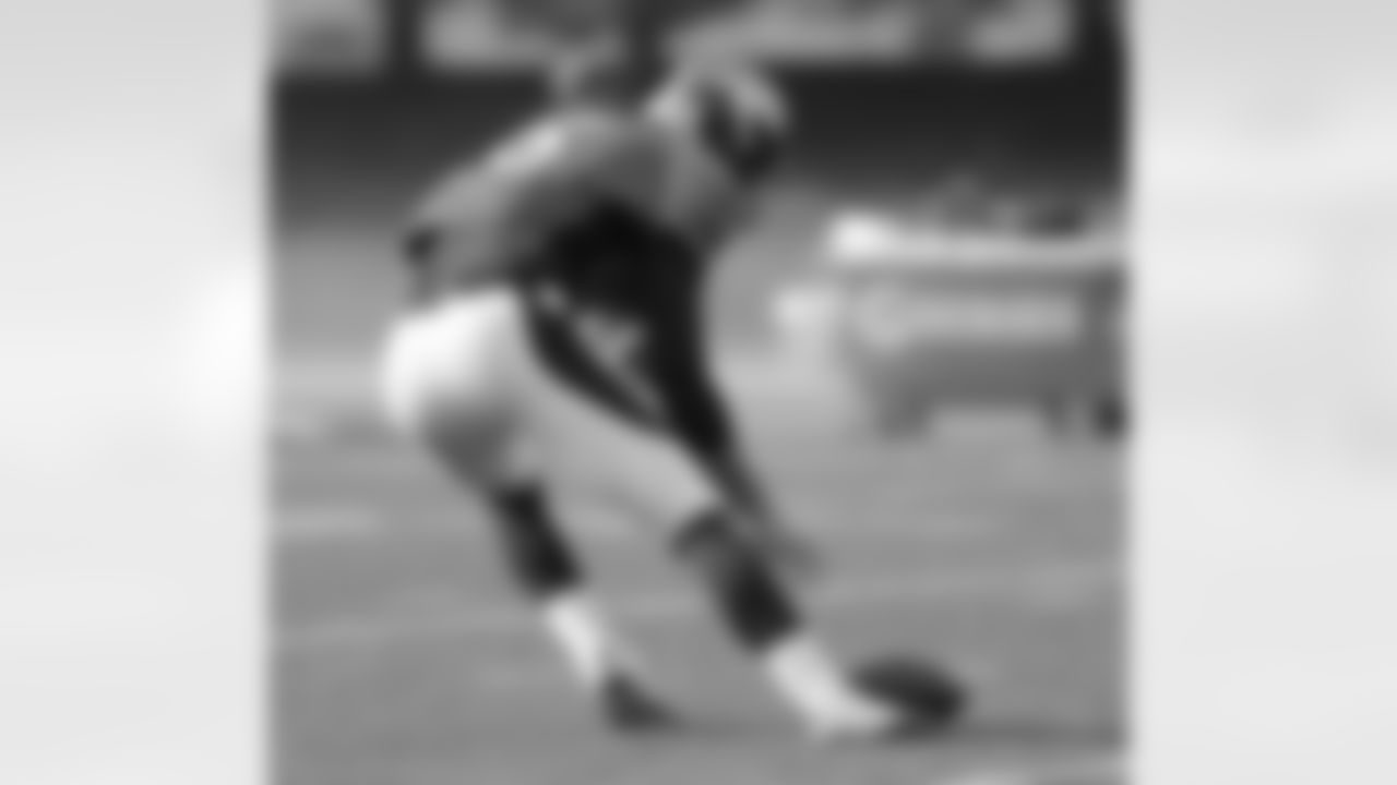 QB Brock Osweiler bends down to scoop up the pigskin.