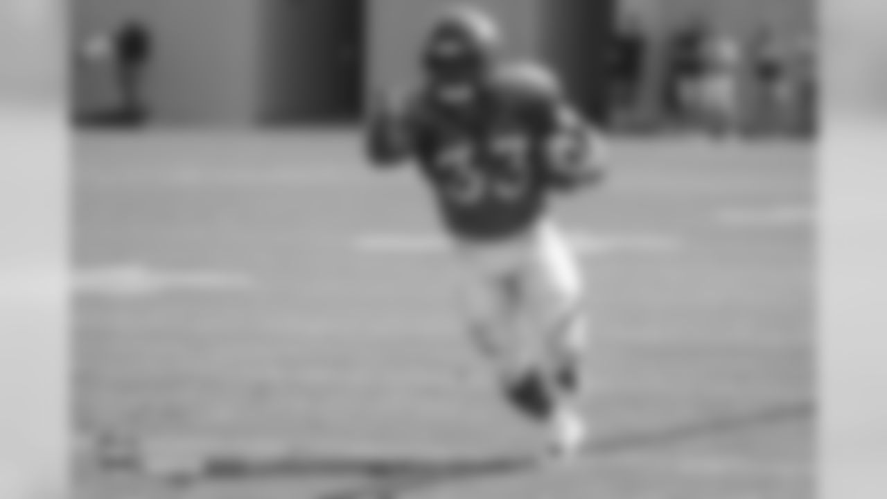 Running back De'Angelo Henderson Sr. (33) points upfield to set up a block during the ninth day of training camp on August 7, 2018, at UCHealth Training Center.