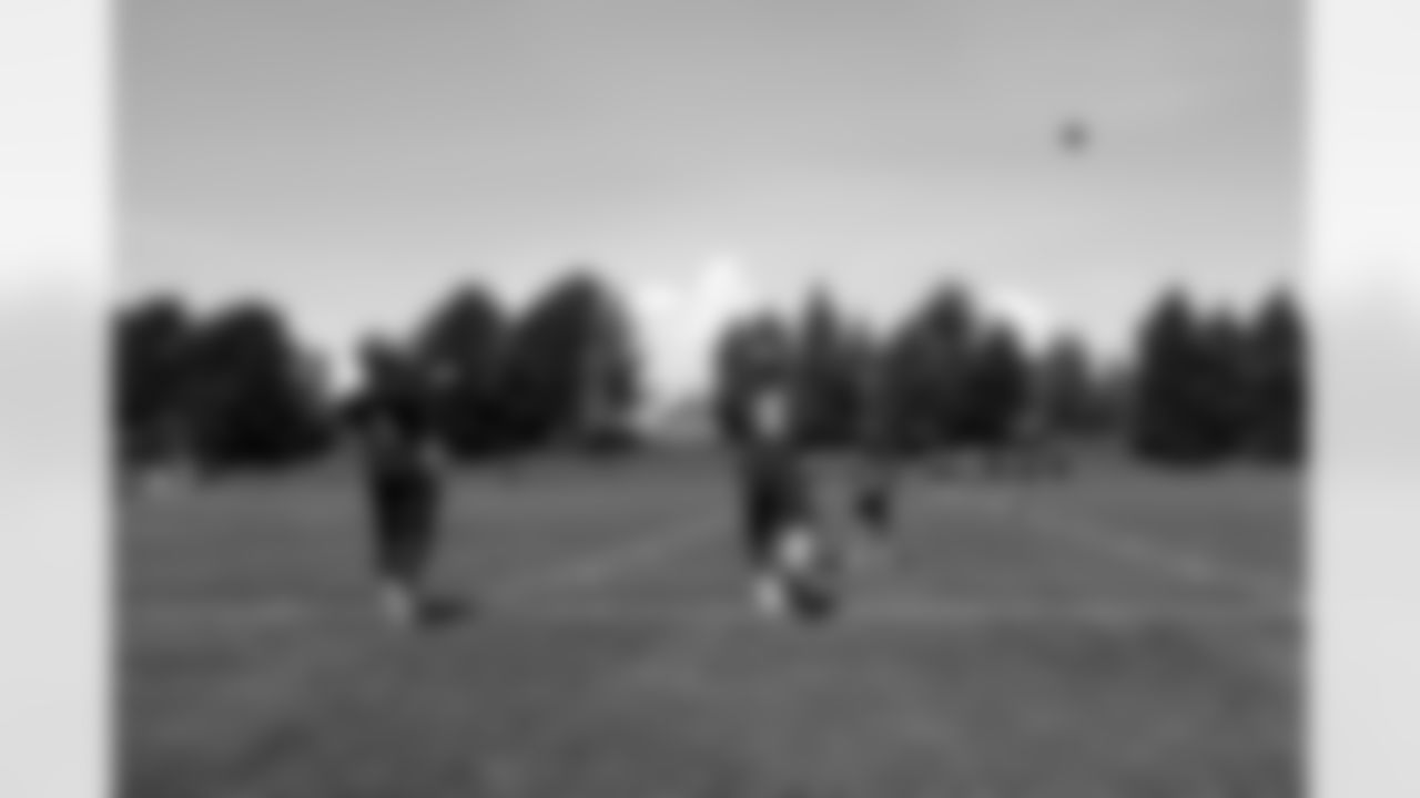 QBs Adam Weber and Brock Osweiler throw passes during practice.