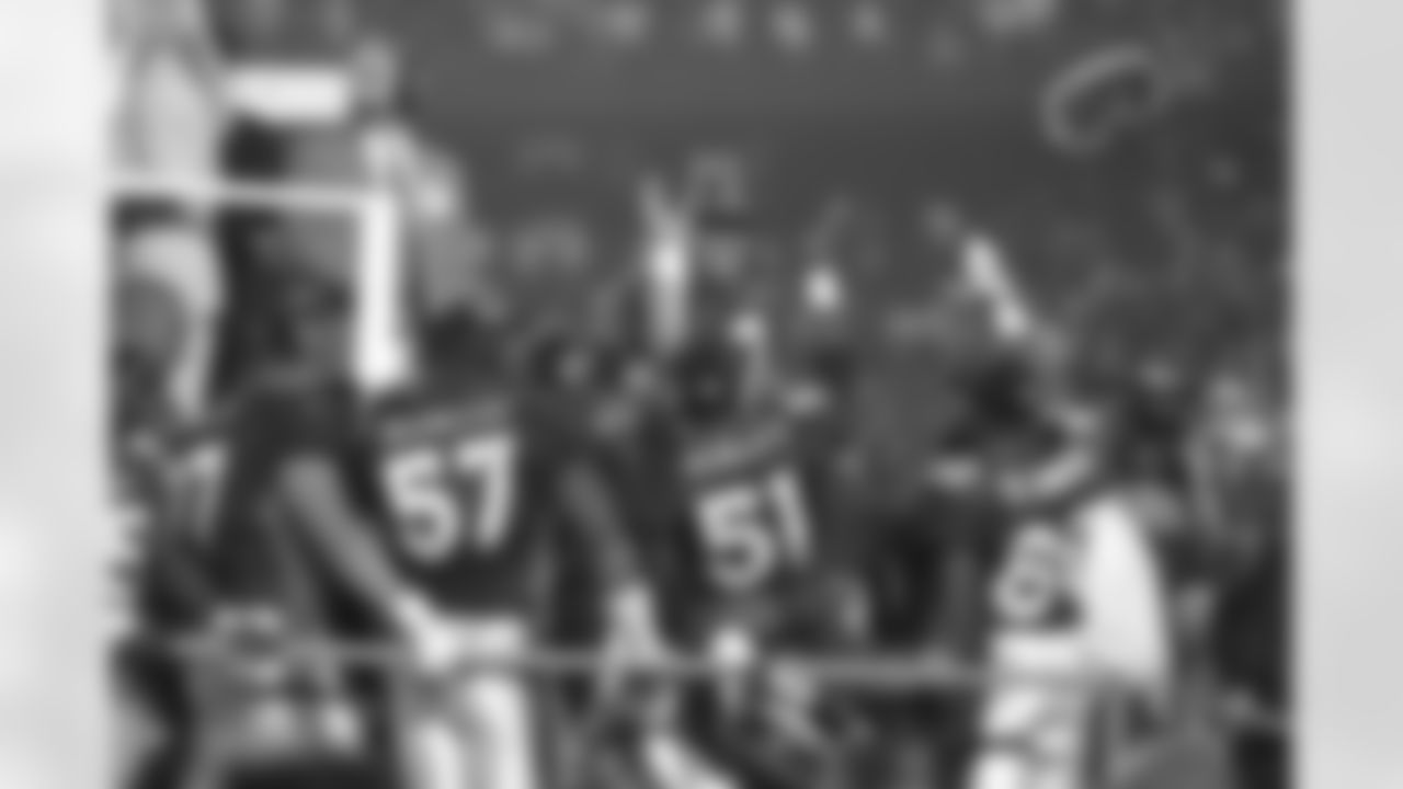 John Elway gets a high five from John Mobley and the rest of his teammates on stage during the trophy presentation after Super Bowl XXXII against the Green Bay Packers at Qualcomm Stadium in San Diego, CA on January 25, 1998.