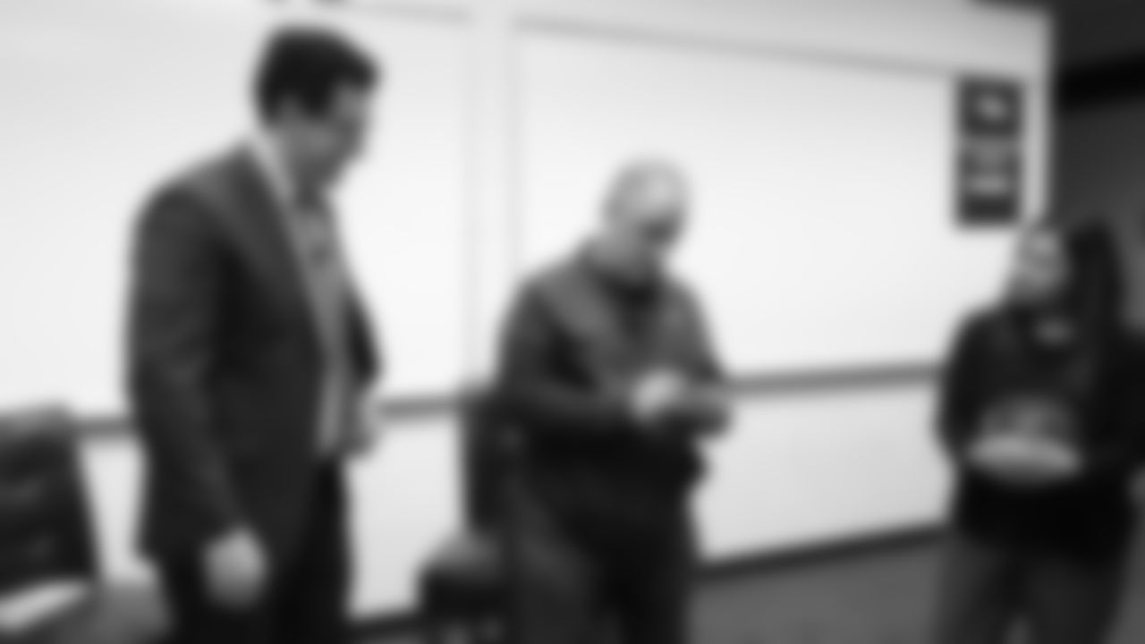 Head Coach Vic Fangio reeds off a raffle number at a meet-and-greet visit with team employees at Broncos Stadium at Mile High on March 19, 2019.