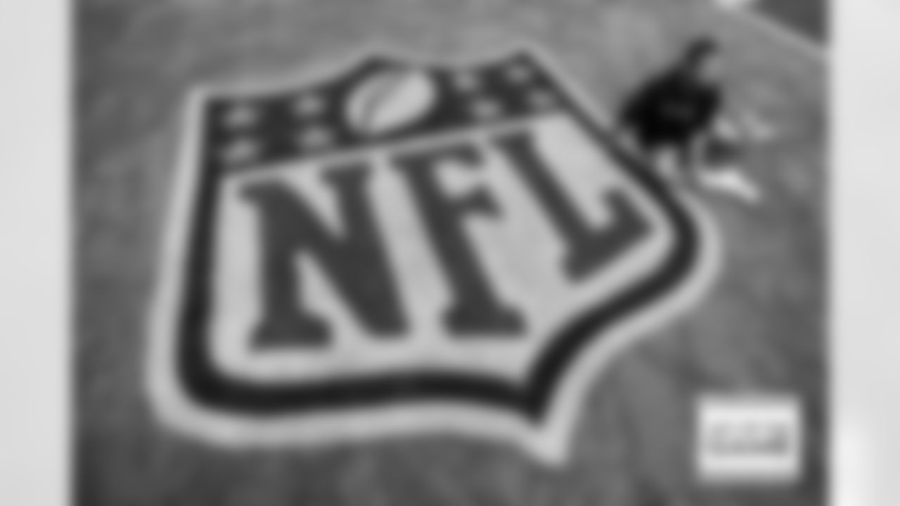 Pat Surtain II stretches next to the NFL shield logo before the Broncos' Week 4 game against the Chicago Bears at Soldier Field in Chicago, Illinois on October 1, 2023. Photo by Ben Swanson / Denver Broncos