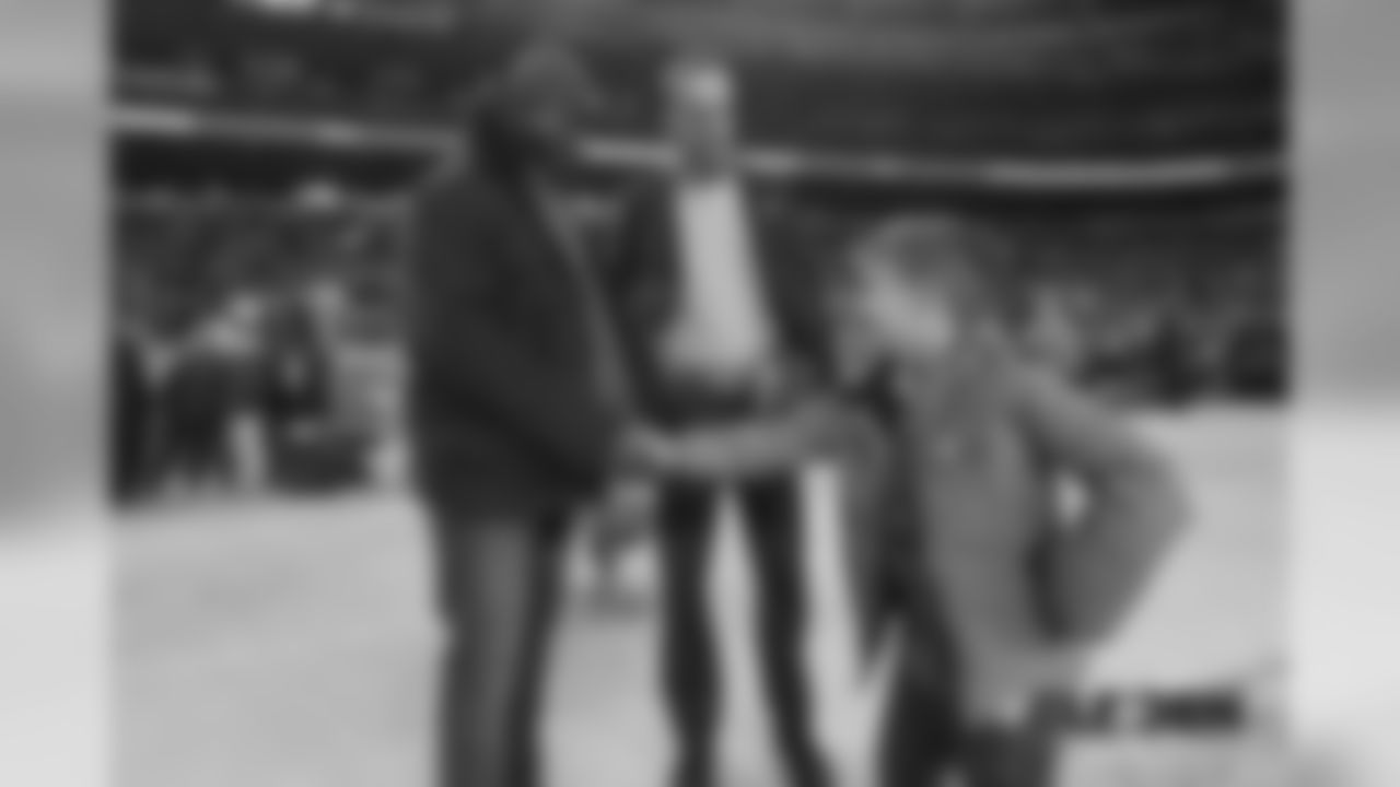 Al Wilson shakes hands with Marshall Manning, Peyton's son, before the Broncos' Week 15 game against the Cleveland Browns at Broncos Stadium at Mile High on December 15, 2018.