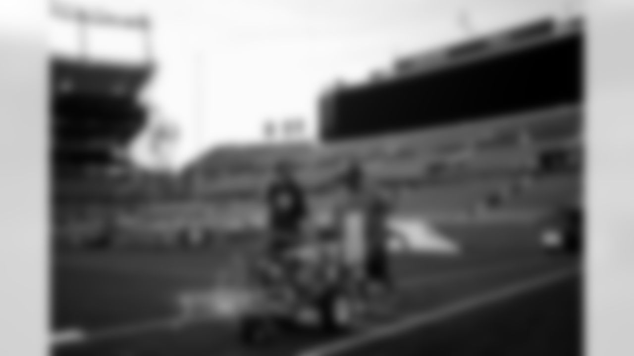 Members of the stadium's turf crew paint the field at Empower Field at Mile High on September 23, 2021 ahead of the team's Week 3 home opener. (Photo by Ben Swanson)