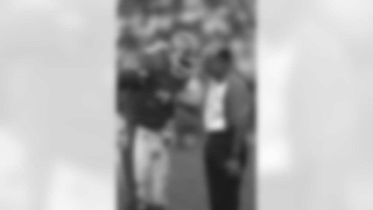 Defensive back Broderick Thompson talks with trainer Steve Antonopulos during an August 1995 win (20-17) against Dallas.