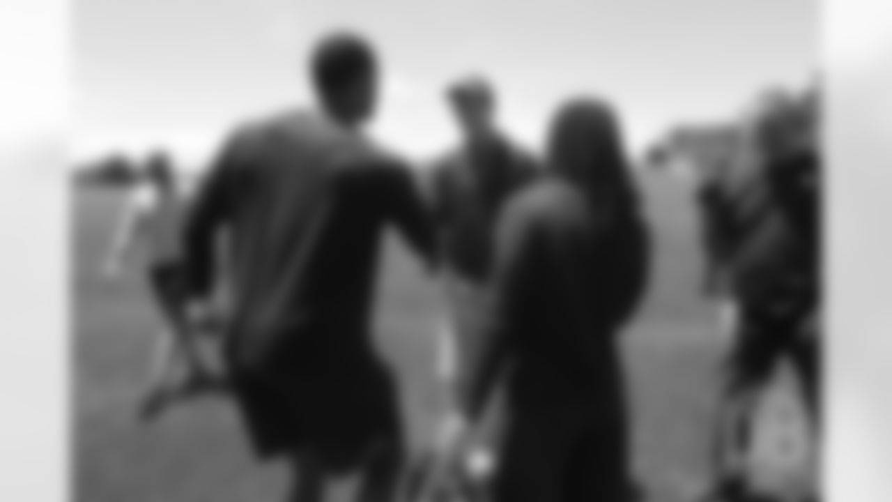 Justin Hollins and Devontae Jackson greet former Broncos quarterback Peyton Manning after the Broncos' practice on the eight day of their OTAs on May 30, 2019.