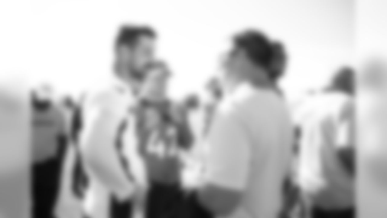Brandon McManus talks with Broncos alumni as they watch the team's walkthrough and meet with current players and coaches afterward on October 12, 2019. (Photo by Jeremy Rincon)