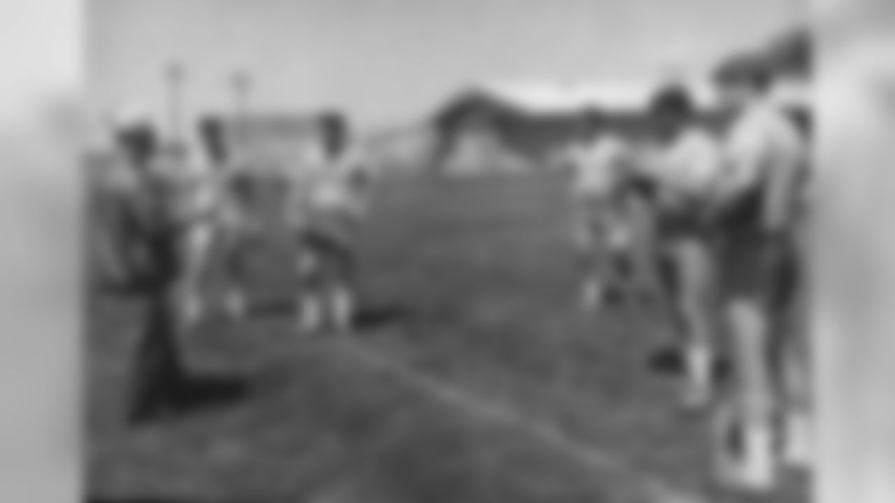 Lou Saban coaches players at training camp in 1967.