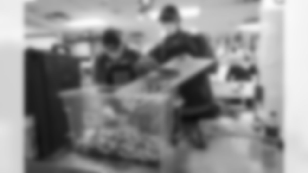Quinn Bailey, Calvin Anderson and other members of the Broncos offensive line help to prepare Thanksgiving meals at Denver Rescue Mission on Tuesday, November 23, 2021.