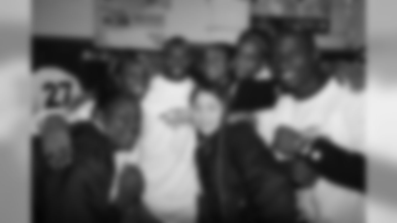 Andre Hall and Karl Paymah take a group photo at the ceremony for the grand opening of the Darrent Williams Memorial Teen Center at the Denver Broncos Boys & Girls Club in 2007.