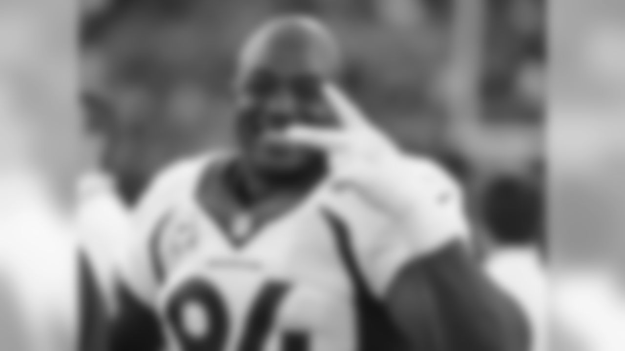 Denver Broncos DeMarcus Ware (94) flashes a smile from the bench area as Denver leads the Oakland Raiders 41-17 late in the 4th quarter of the NFL game at O.Co Coliseum in Oakland,CA November 9, 2014.