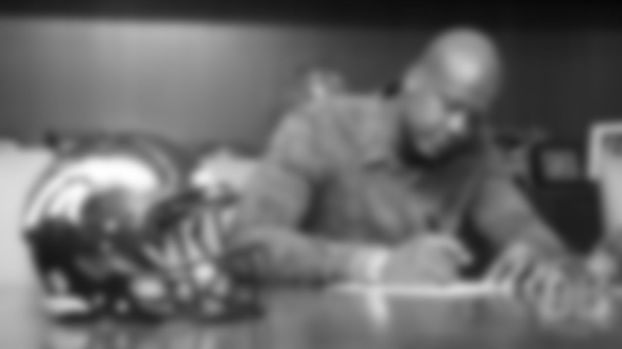 Ja'Wuan James signs his contract as a free agent during his first day as a Bronco at UCHealth Training Center on March 15, 2019.